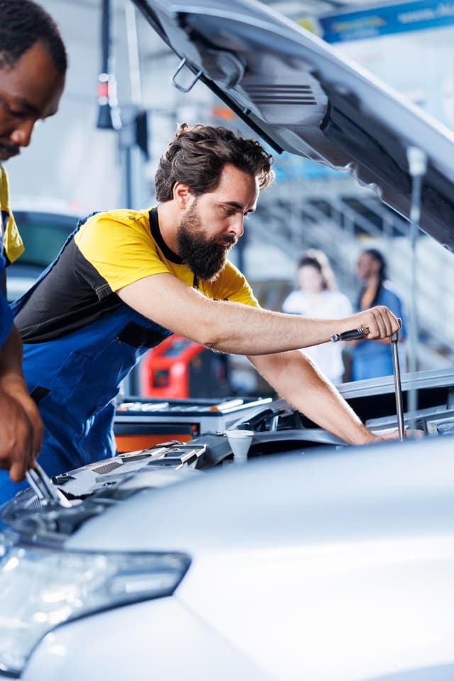 Mechanic working on a vehicle engine