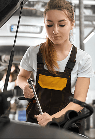 Technician working under the hood during a quick oil change