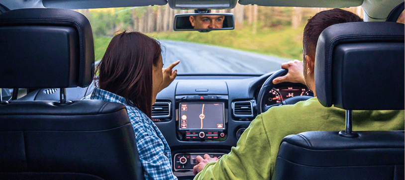 Couple driving with fresh cabin air and navigation on the dashboard