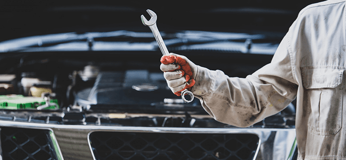 Mechanic inspecting a vehicle at Ten Minute Oil Change