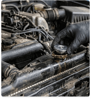 Mechanic wearing black gloves working on an engine