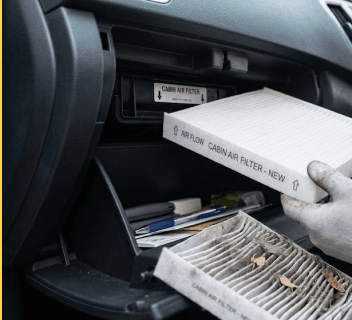 Technician installing a clean cabin air filter