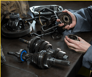 Mechanic working on transmission gears and components