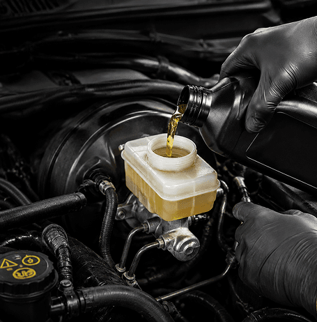 Technician performing a brake fluid flush service