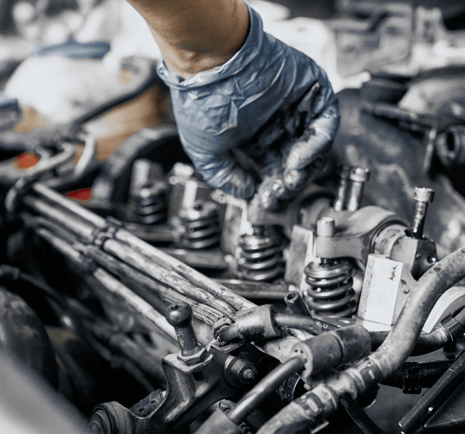 Mechanic inspecting spark plugs during engine service