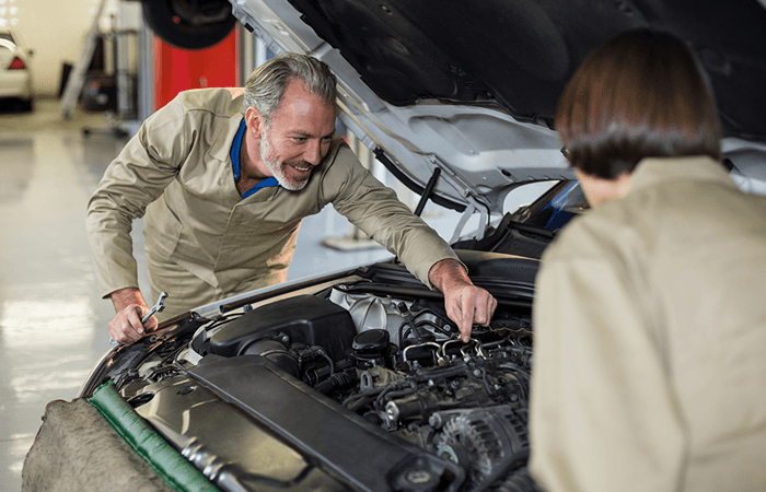 Ten Minute Oil Change technicians performing spark plug replacement service
