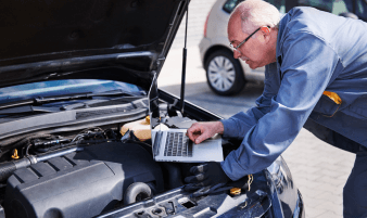 Technician performing emission system diagnostics