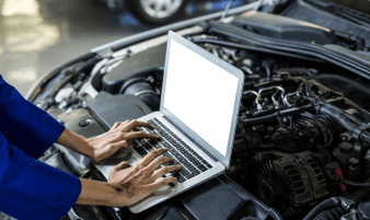 Technician using diagnostic equipment on an engine