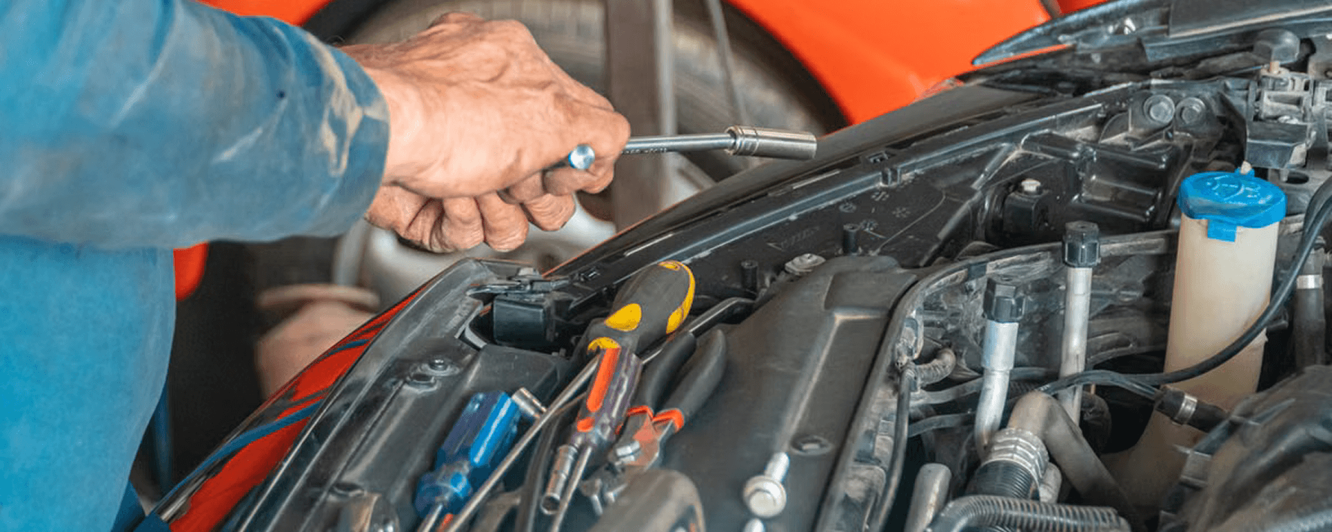 Mechanic working on a vehicle engine