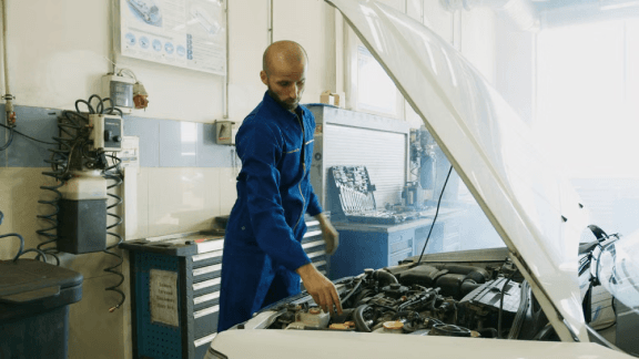 Mechanic servicing a vehicle at Ten Minute Oil Change Garland
