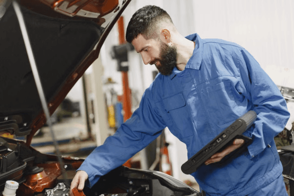 Mechanic with wrenches at Ten Minute Oil Change Garland