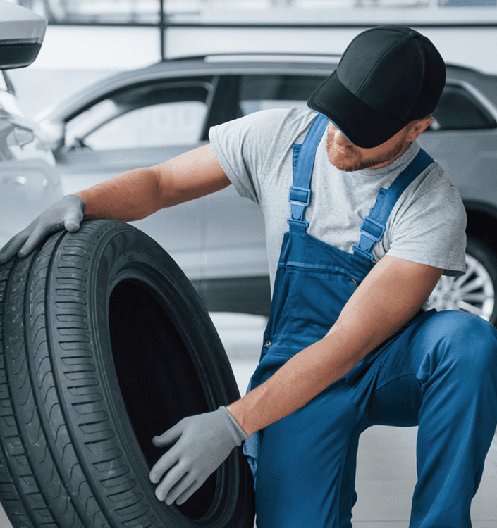 Mechanic holding a tire in the garage