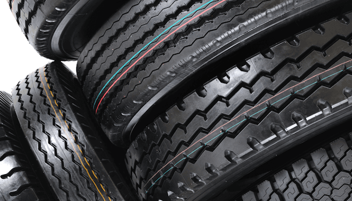 Stack of new car tires with detailed tread