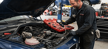 Mechanic performing radiator leakage and pressure testing
