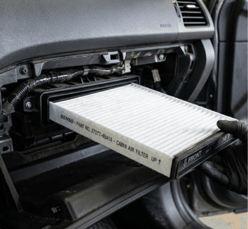 Technician replacing a cabin air filter in a vehicle