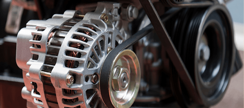 Close-up of a car alternator with serpentine belt around the pulley