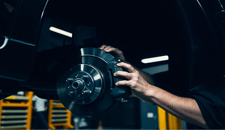 Technician inspecting a brake rotor