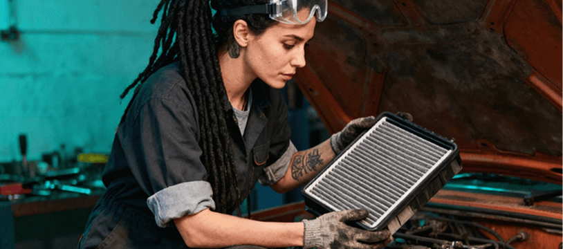 Technician holding a cabin air filter at Ten Minute Oil Change