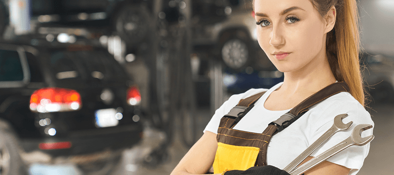 Certified technician holding wrenches at Ten Minute Oil Change