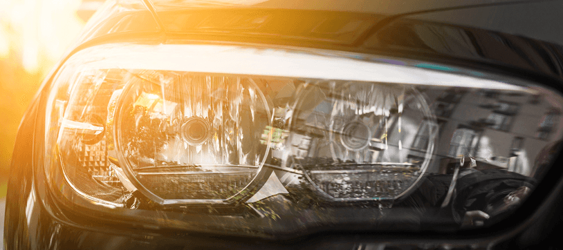 Close-up of a restored car headlight with clear lens