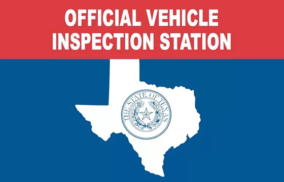 Mechanic inspecting a vehicle at Ten Minute Oil Change Garland